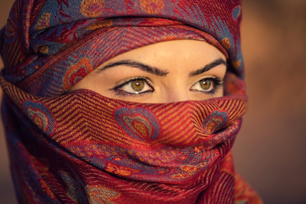 a close up of a woman wearing a scarf