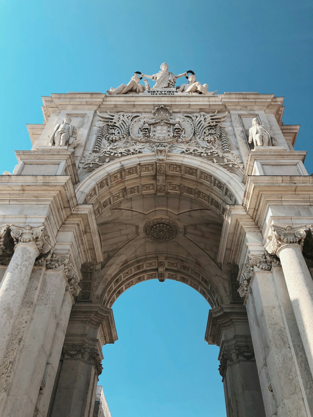 a large arch with statues on top of it