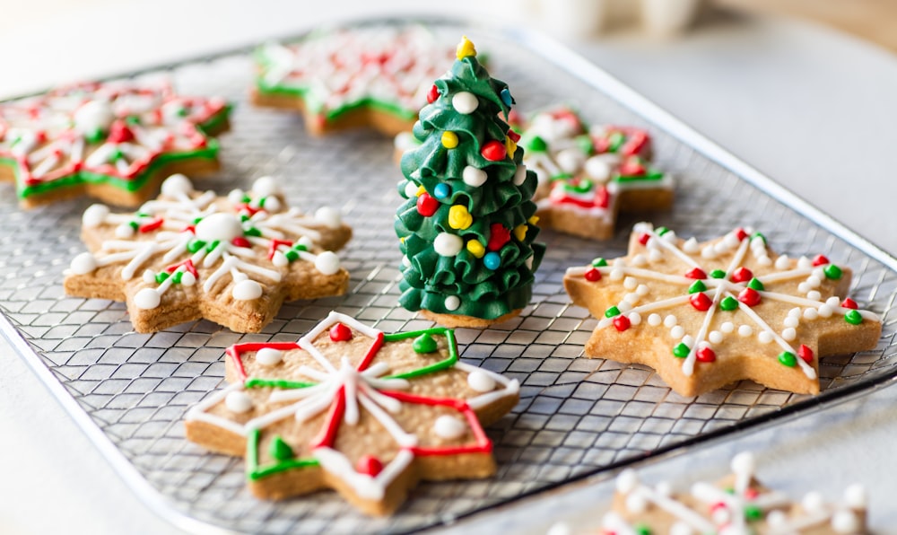 a tray of decorated christmas cookies on a table