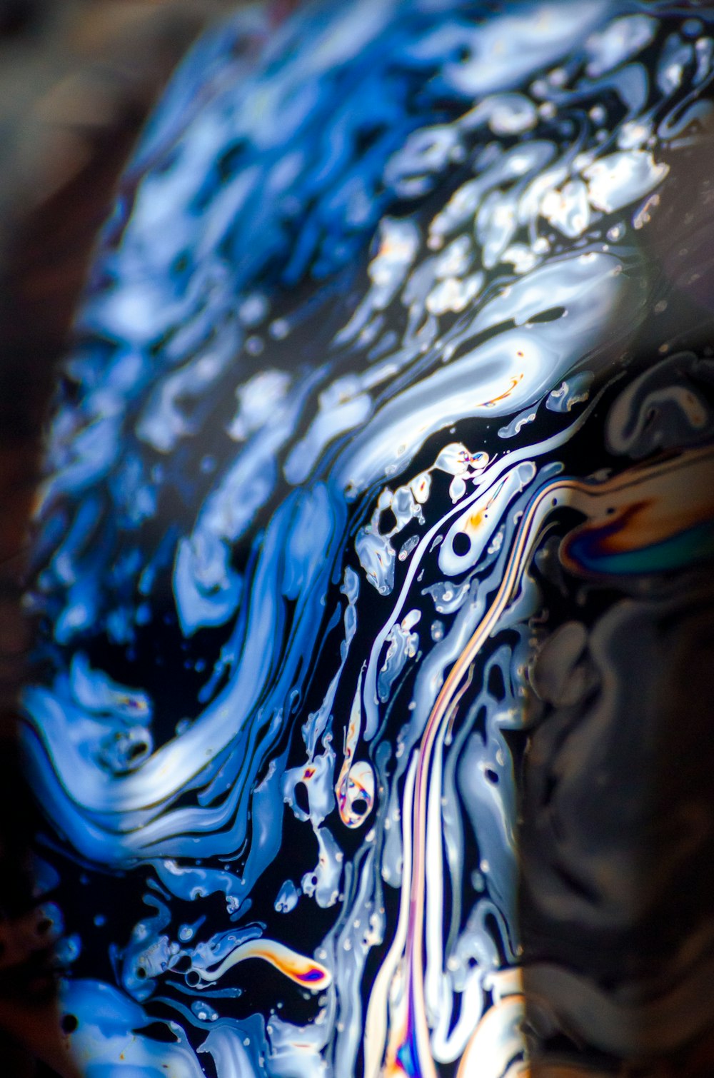 a close up of a blue and black liquid