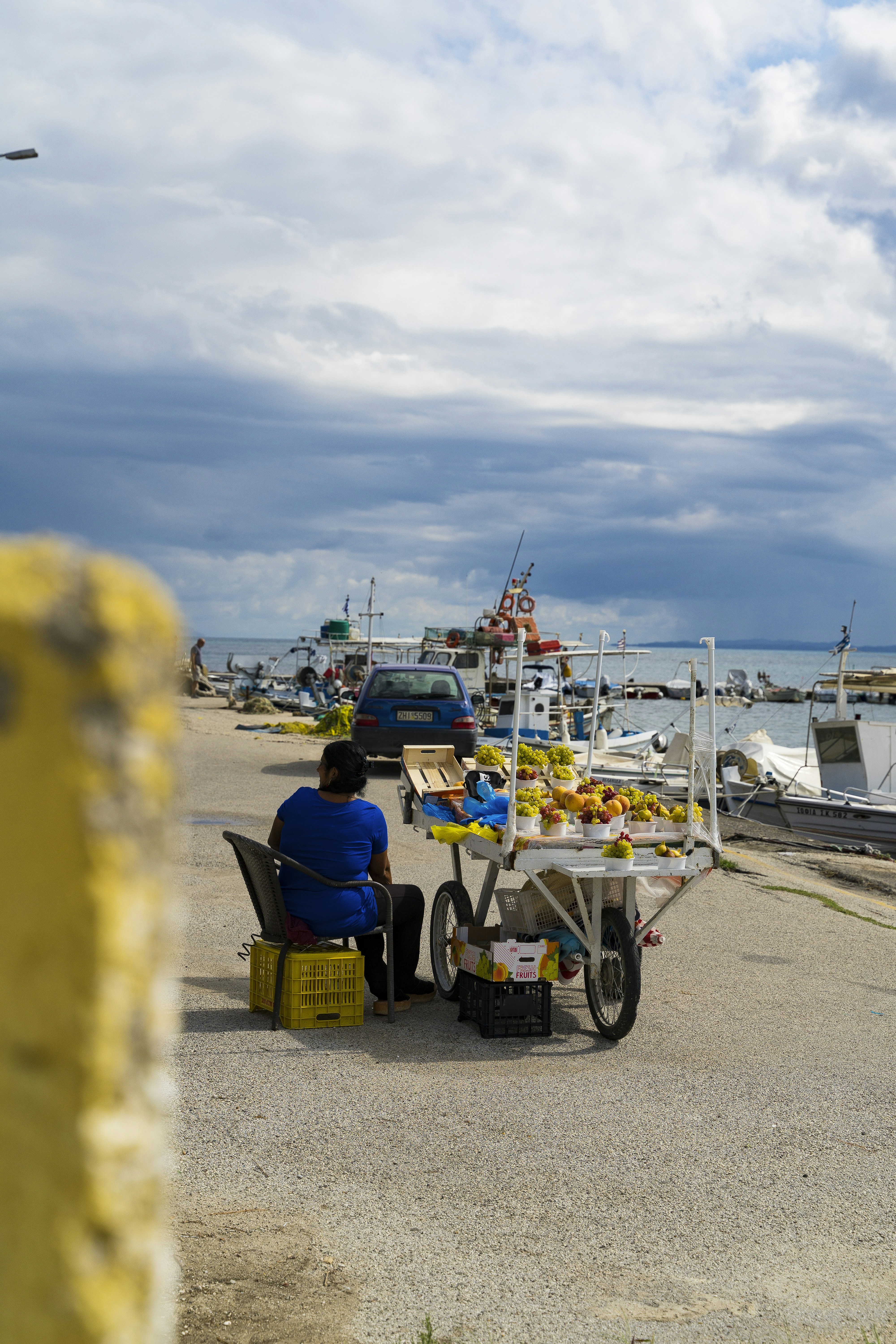 a man sitting at a table near the ocean