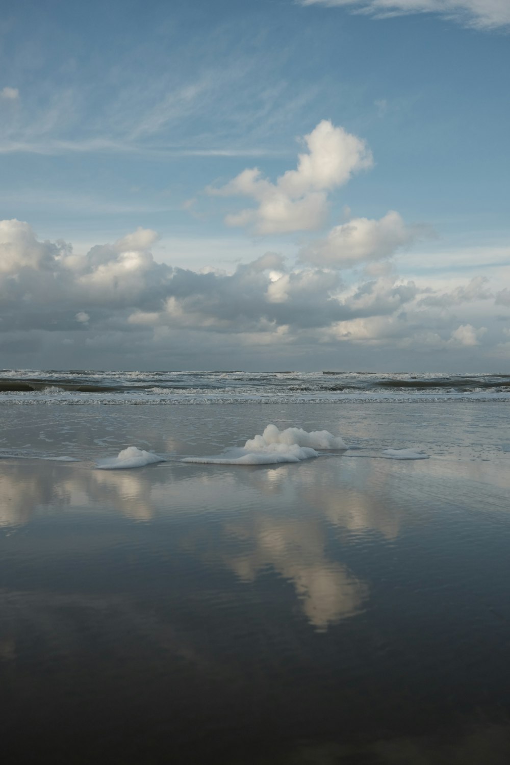 a large body of water sitting under a cloudy sky