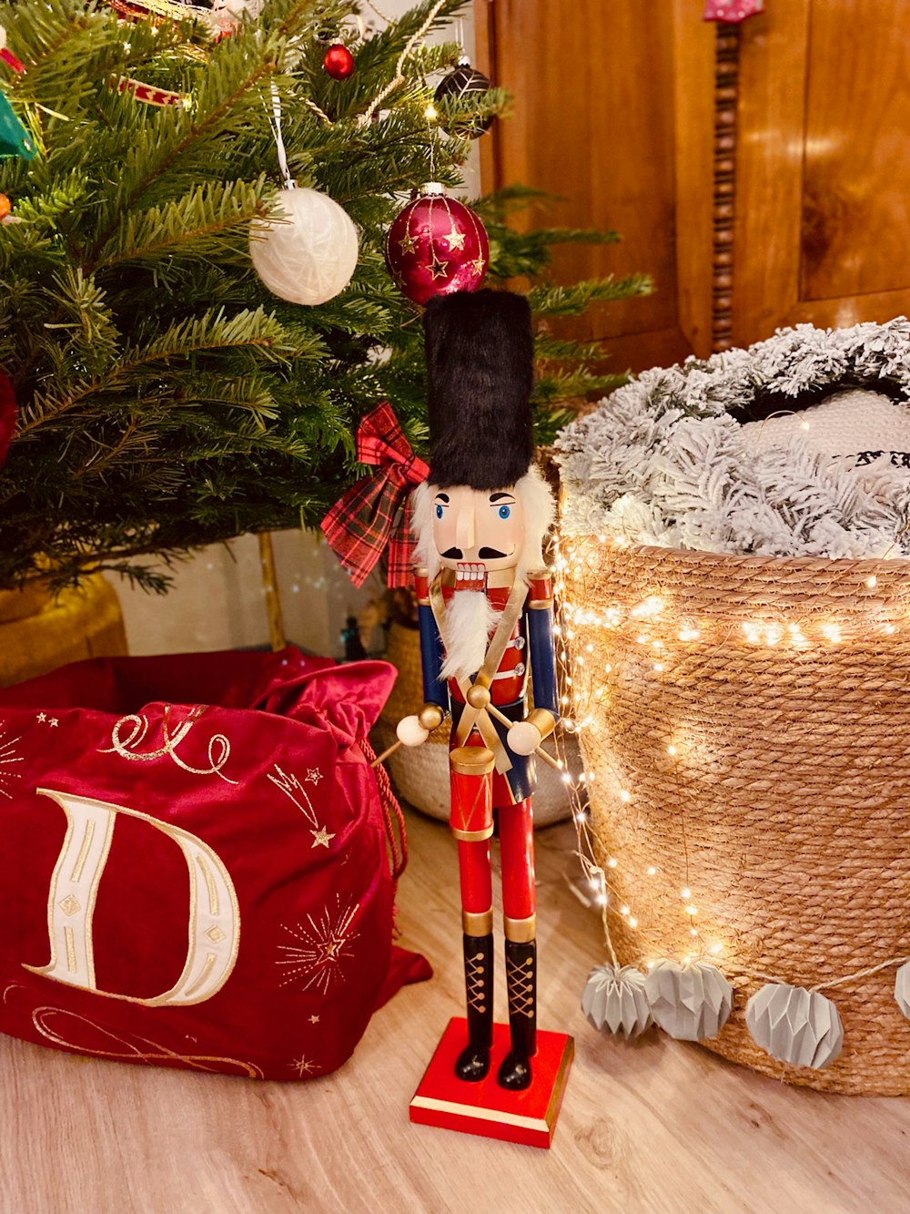 a nutcracker figurine next to a christmas tree