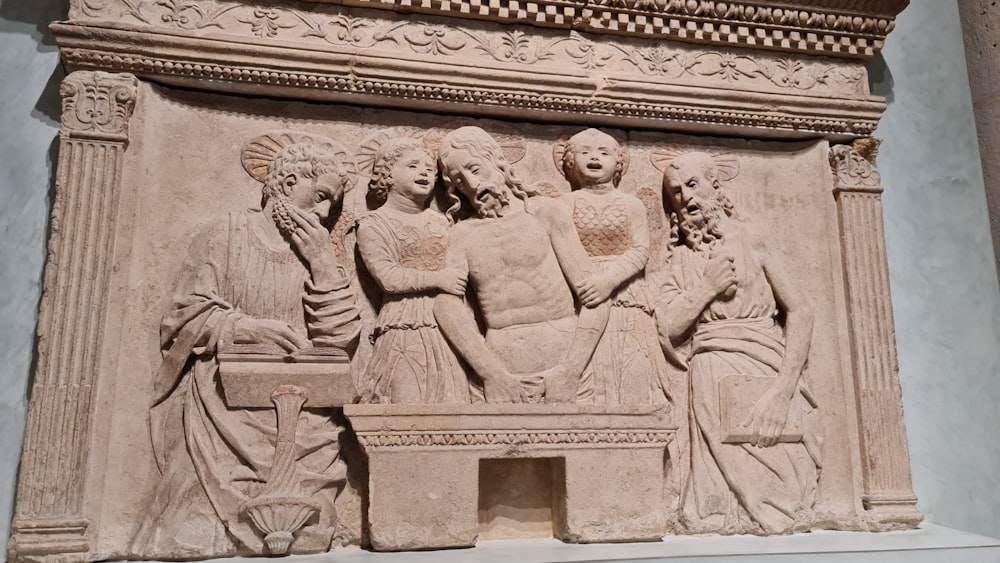 a sculpture of a group of people sitting on a bench