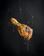 a piece of meat with sprinkles on it