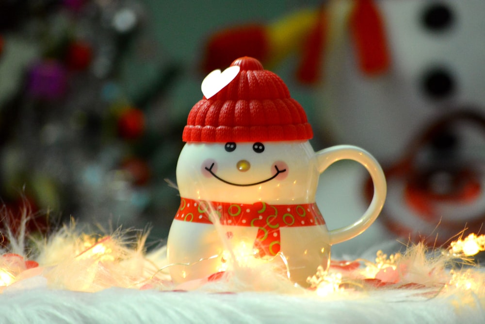 a snowman figurine with a red hat and scarf