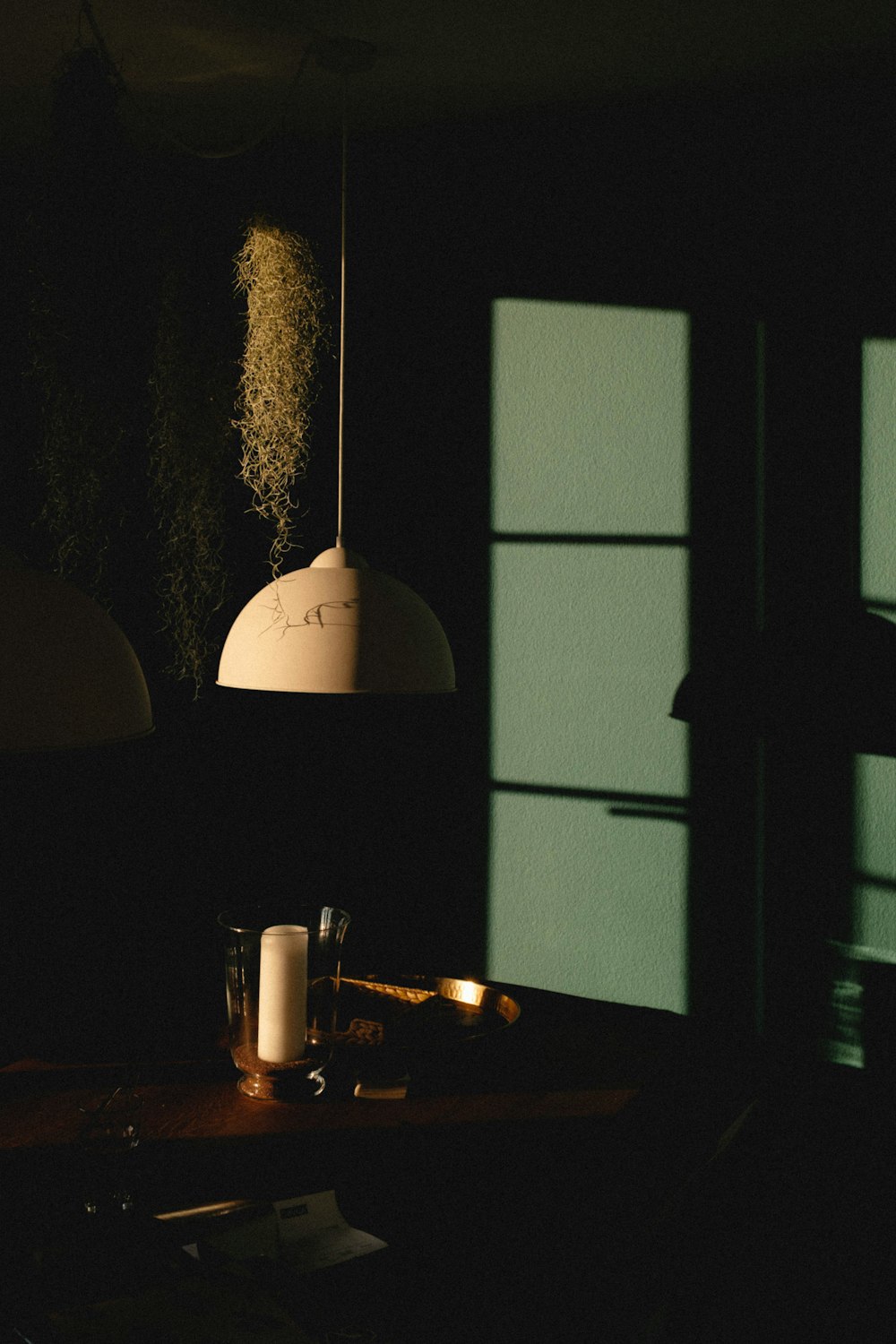 a dark room with a table and a lamp
