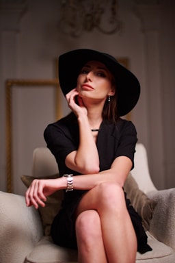 fashion photography,how to photograph a woman sitting on a couch wearing a black hat