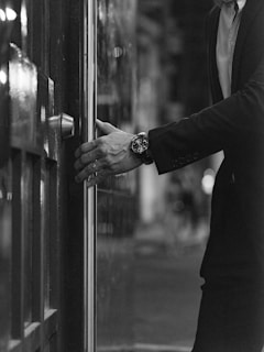 a man in a suit is opening a door