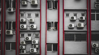 a bunch of air conditioners on a building