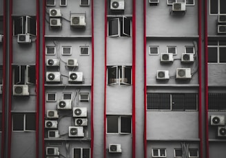 a bunch of air conditioners on a building