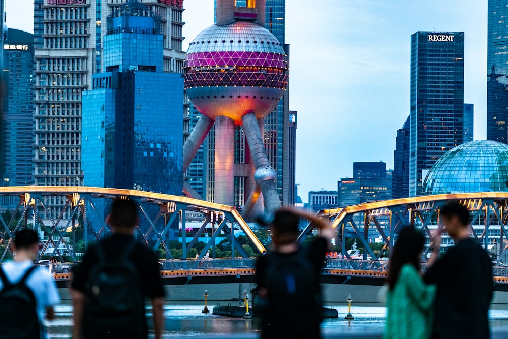 a group of people walking across a bridge