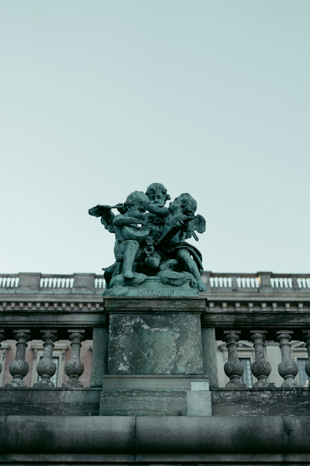 a statue on top of a building with a sky background