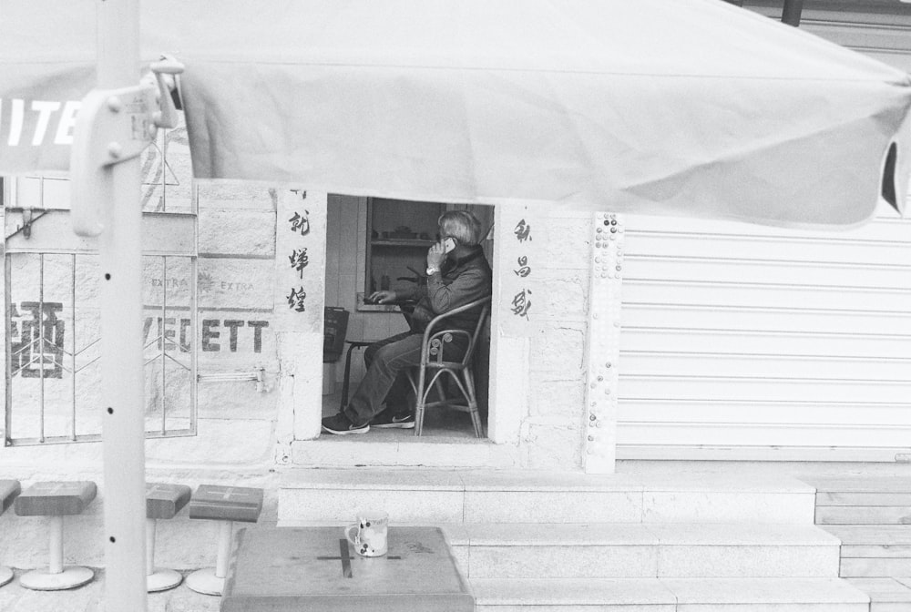 a man sitting in a chair at a table