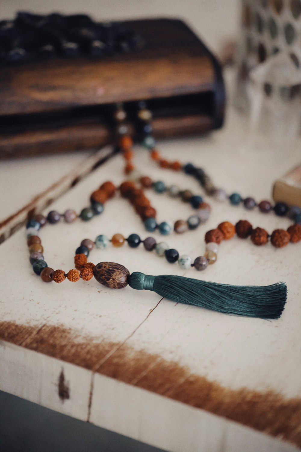 a rosary with a tassel on a table