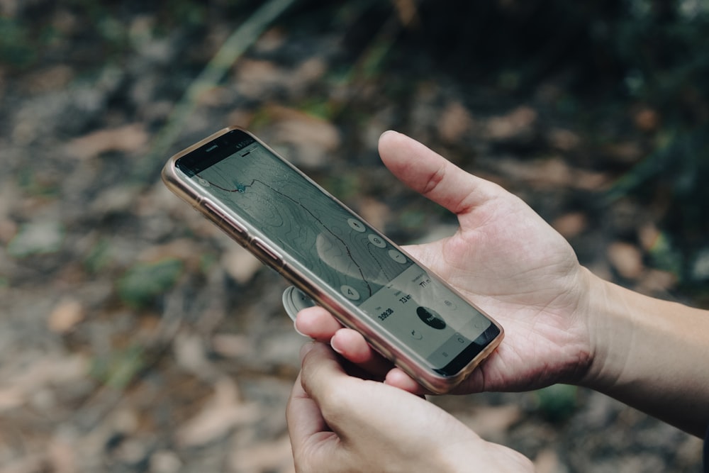 a person holding a cell phone in their hand