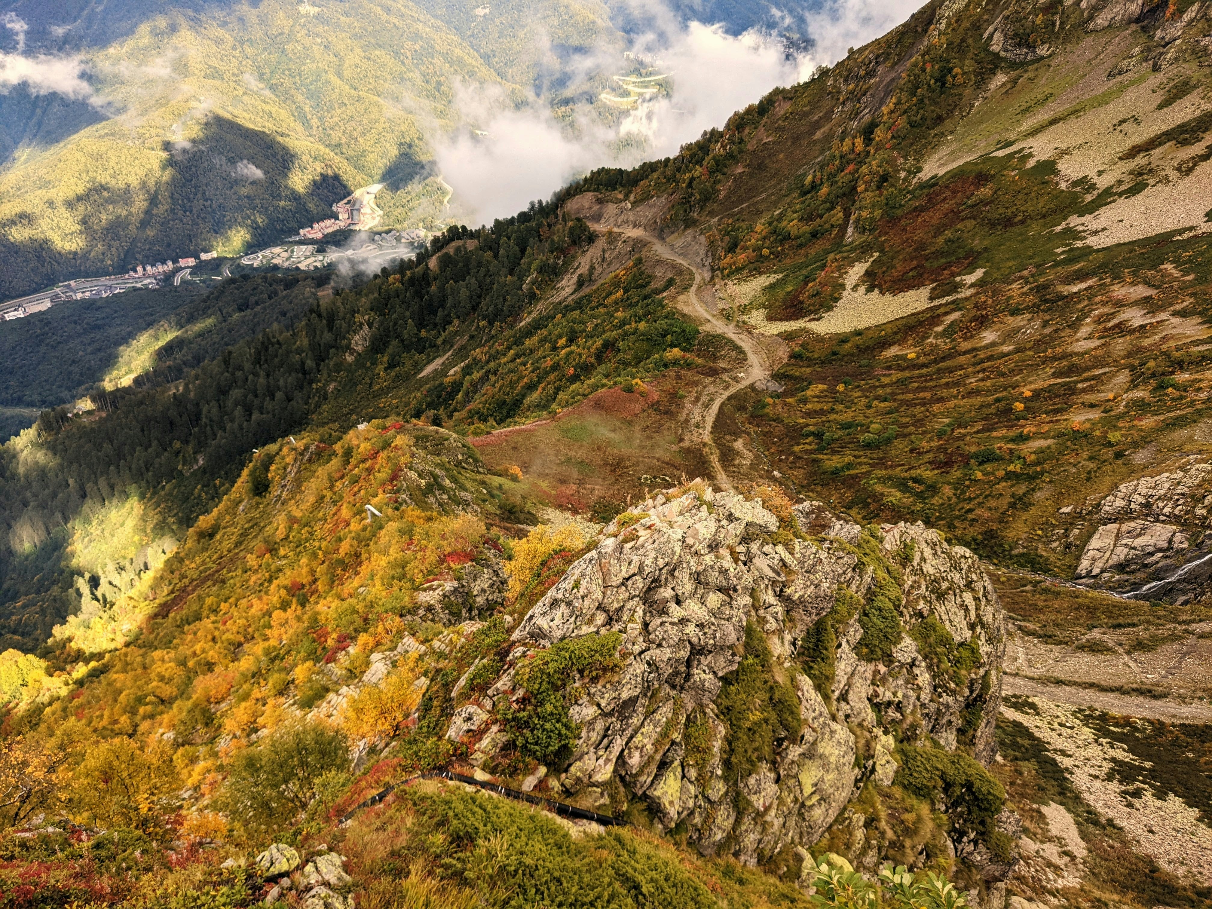 a scenic view of a mountain with a winding road