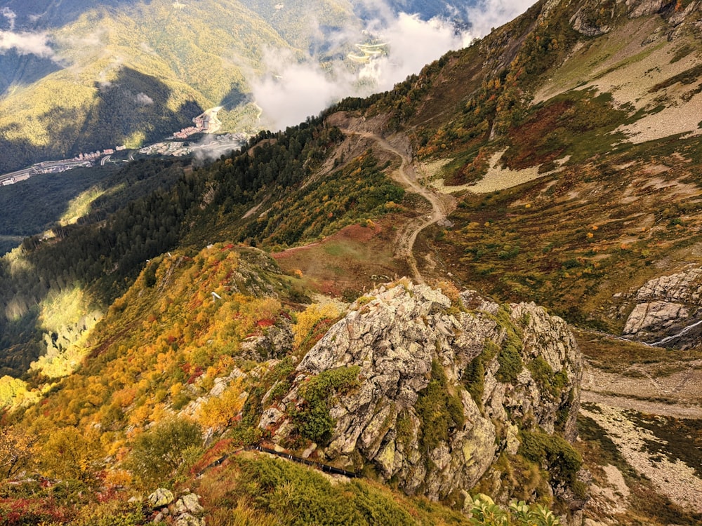 a scenic view of a mountain with a winding road