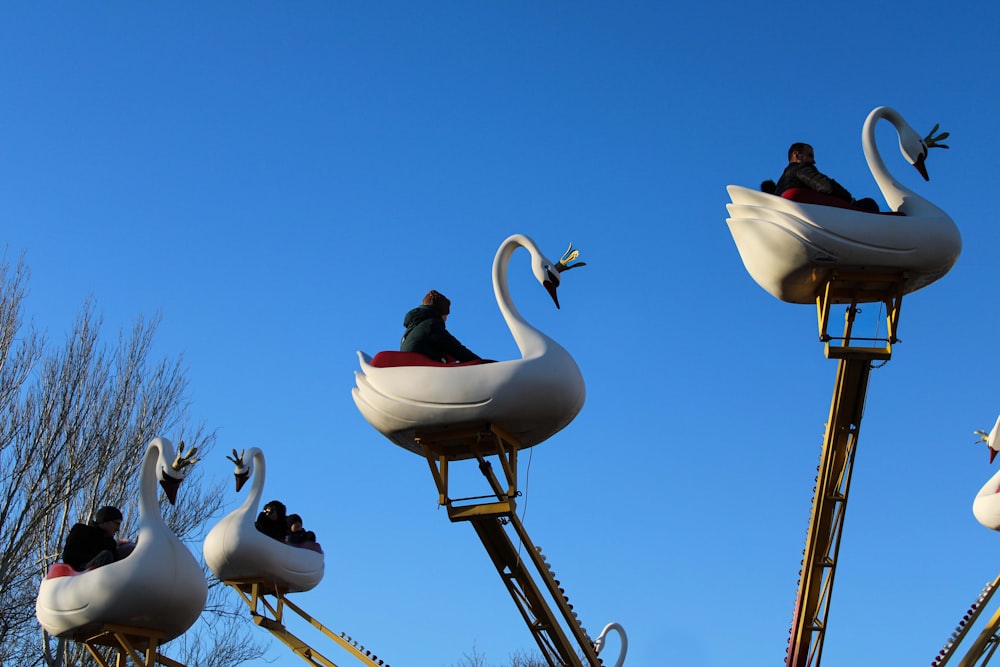 a group of people riding on top of a roller coaster