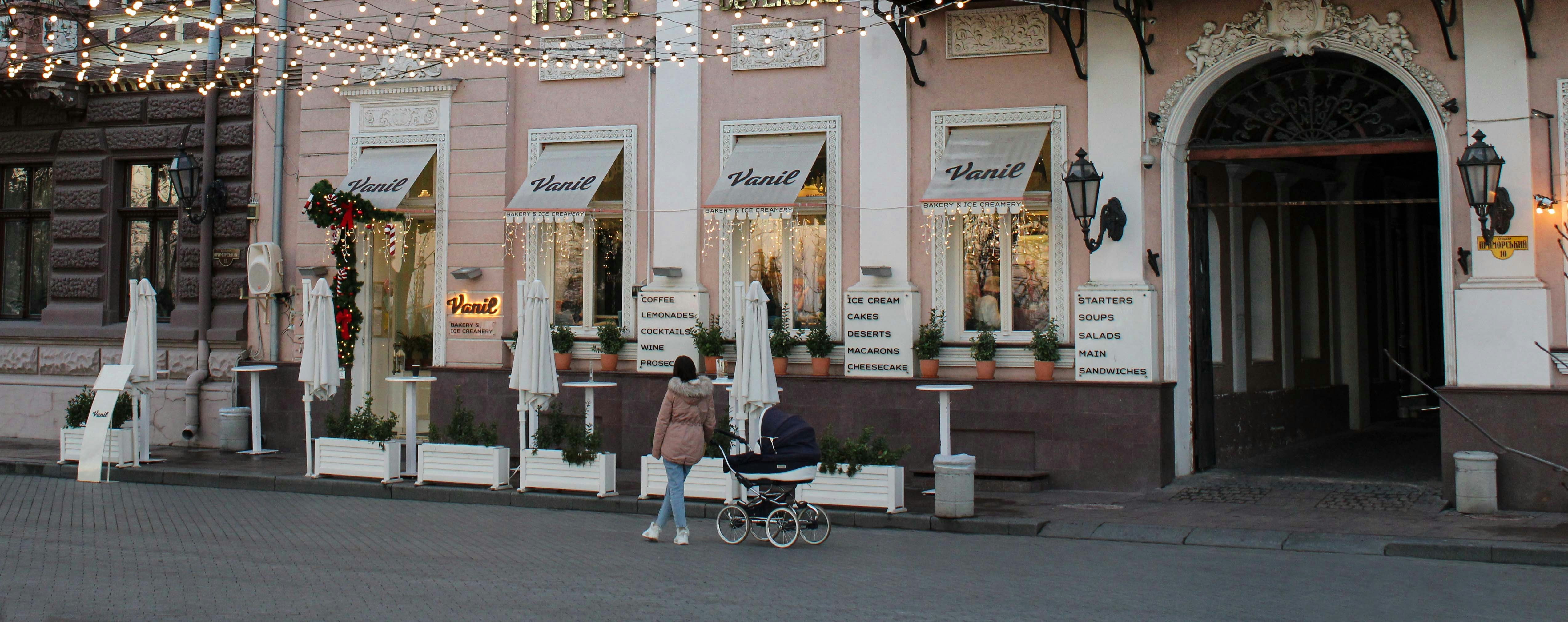 Young woman with a baby near the coffee shop