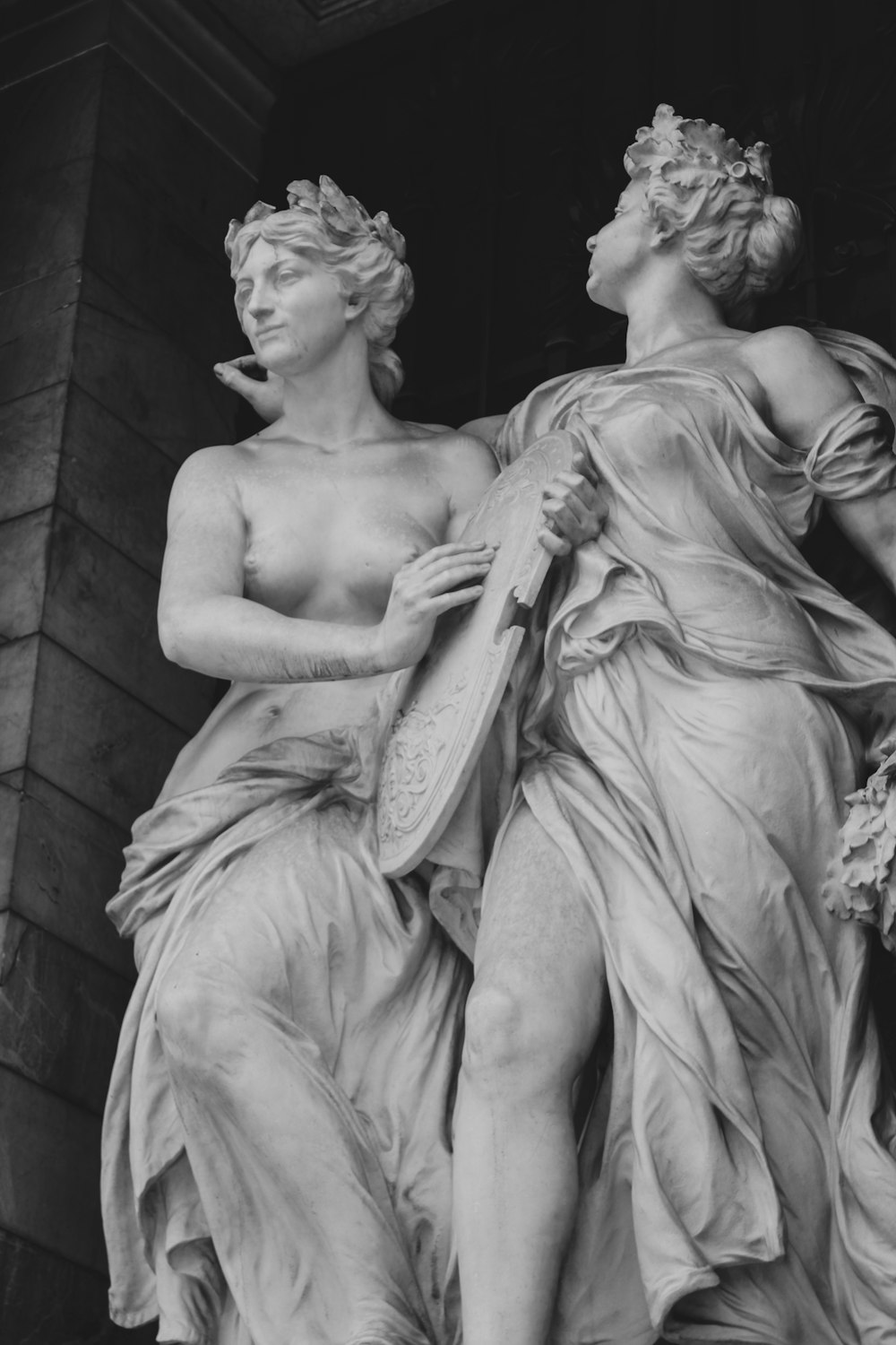 a black and white photo of two statues
