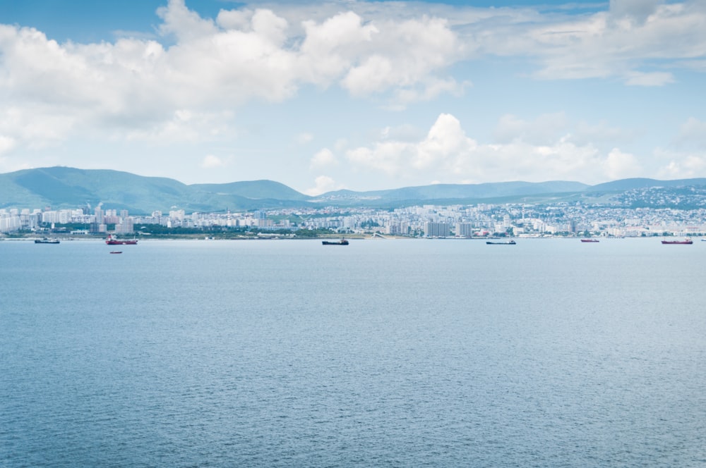 a large body of water with a city in the background