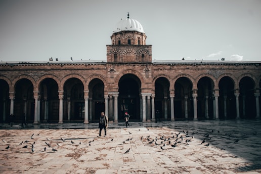 a couple of people standing in front of a building