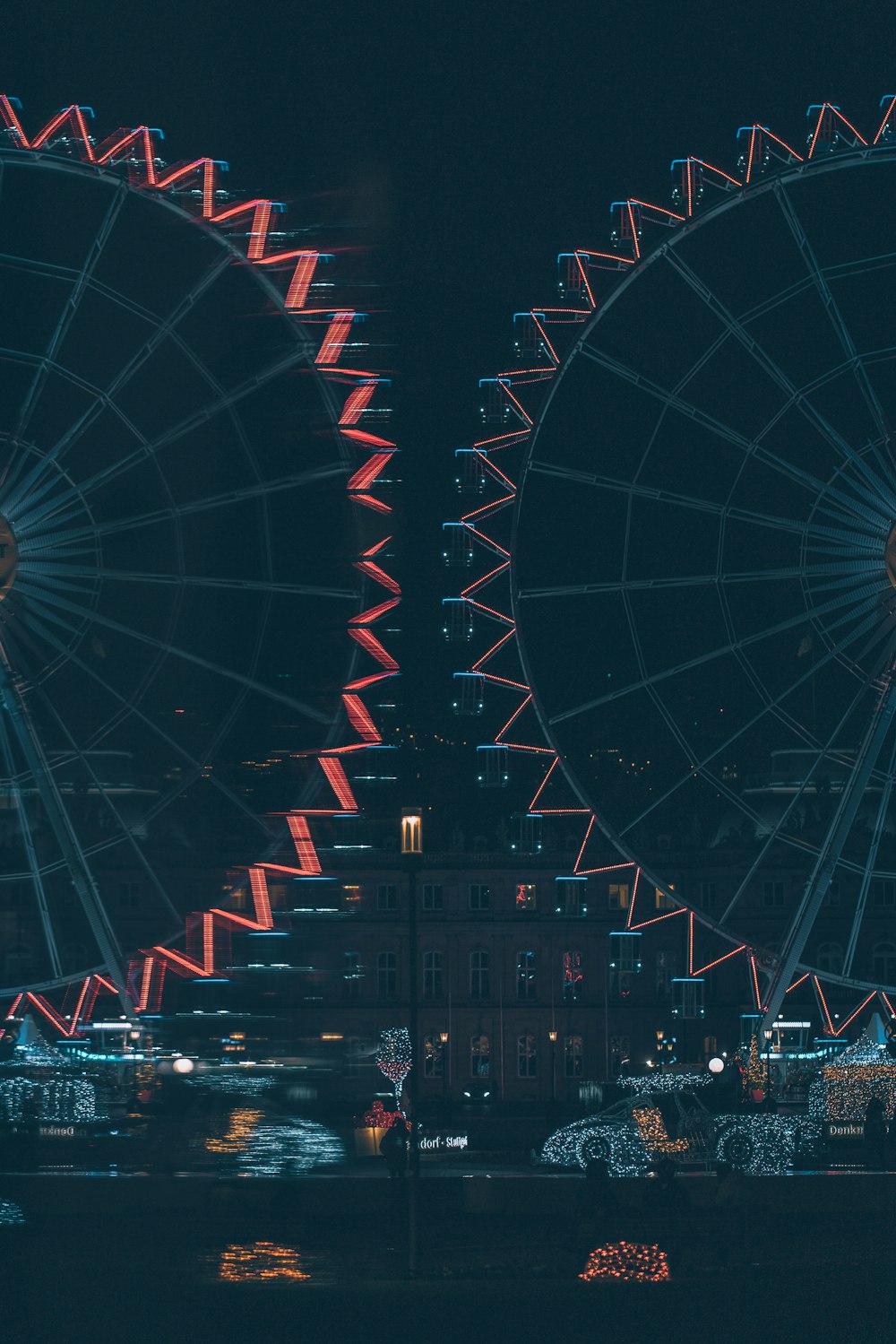 a large ferris wheel sitting next to a tall building