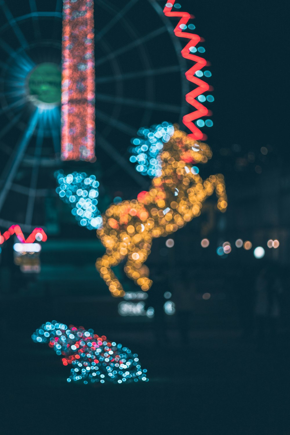 a blurry photo of a ferris wheel at night