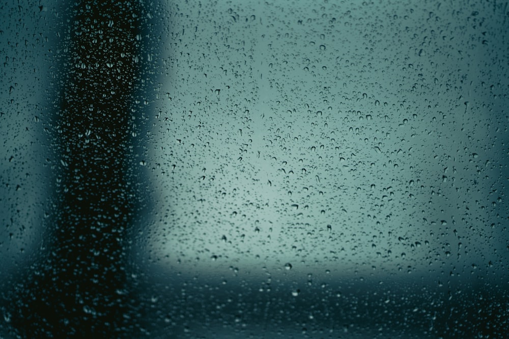 a close up of a window with drops of water on it