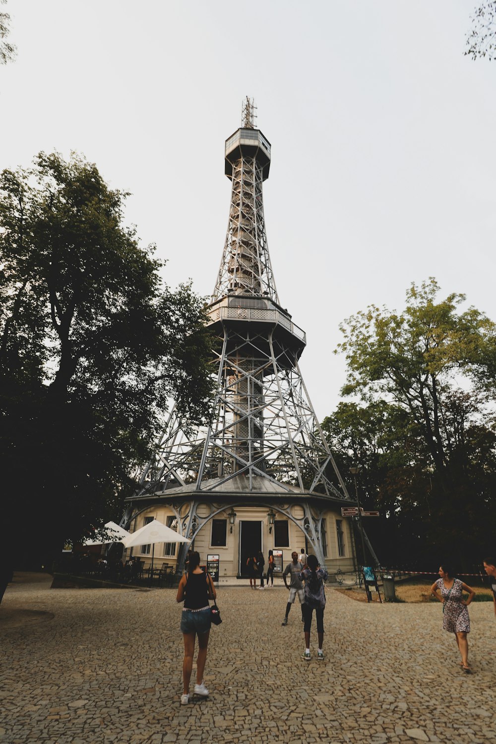 a group of people standing in front of the eiffel tower