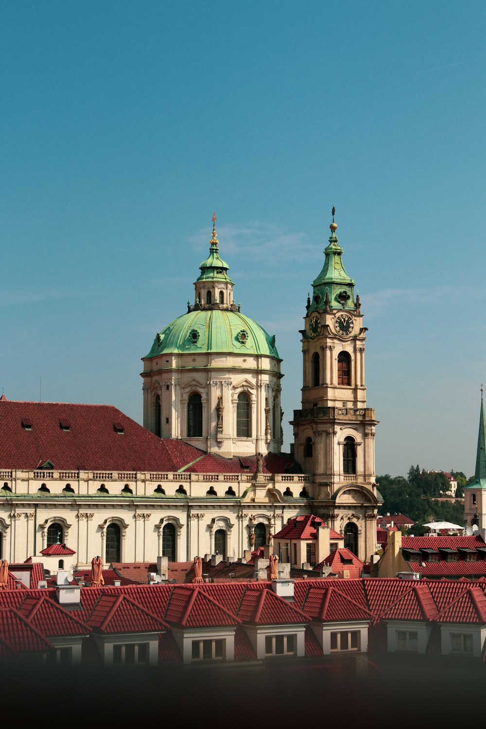 a large building with a green roof and two towers