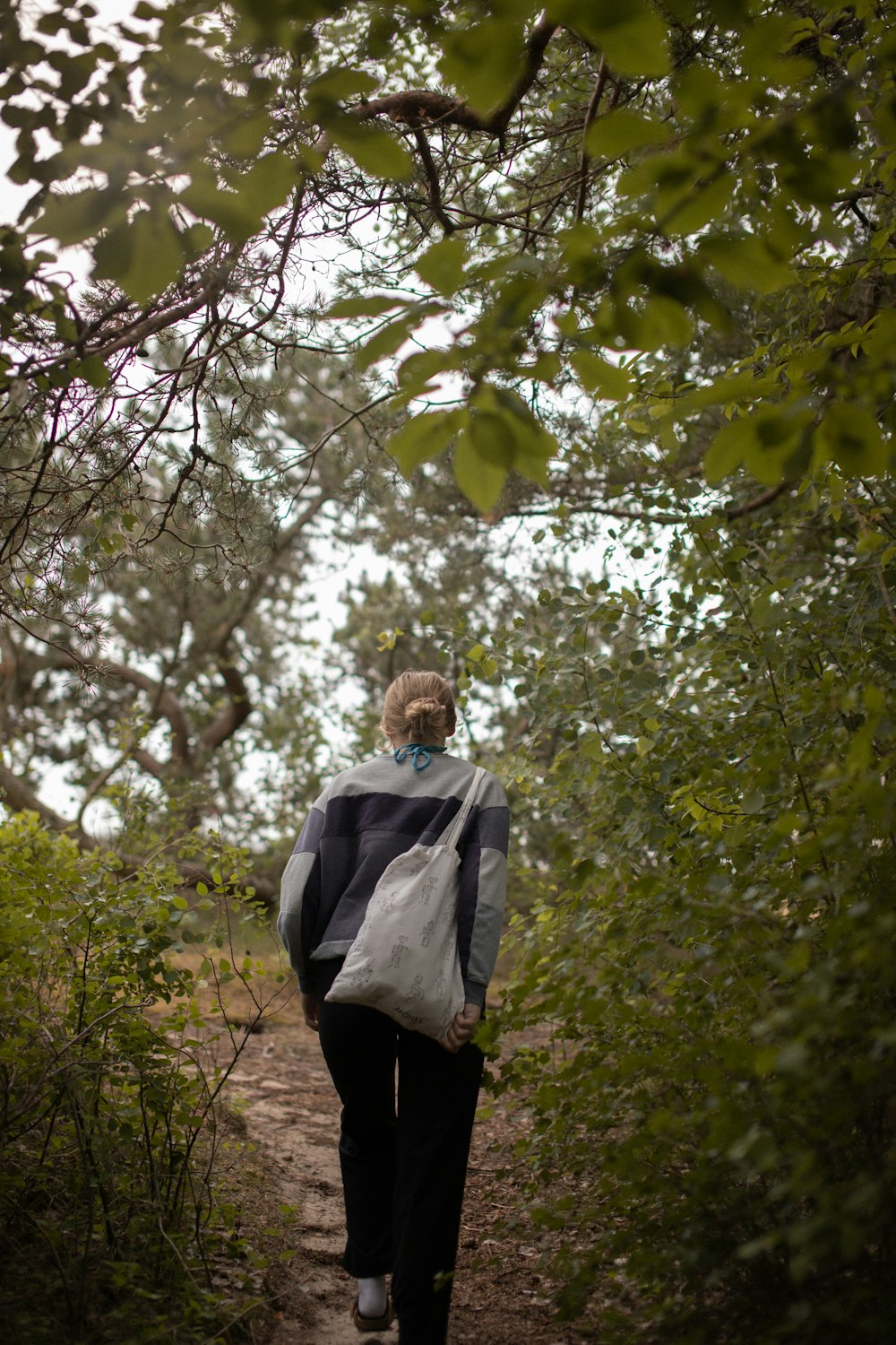 a person walking down a path in the woods