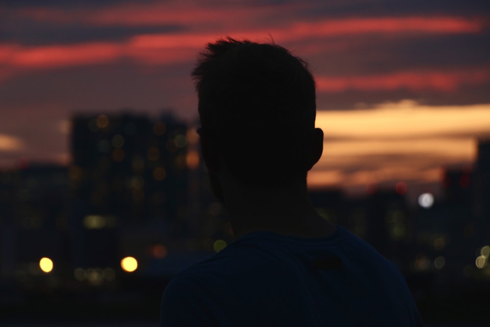 a man standing in front of a city skyline