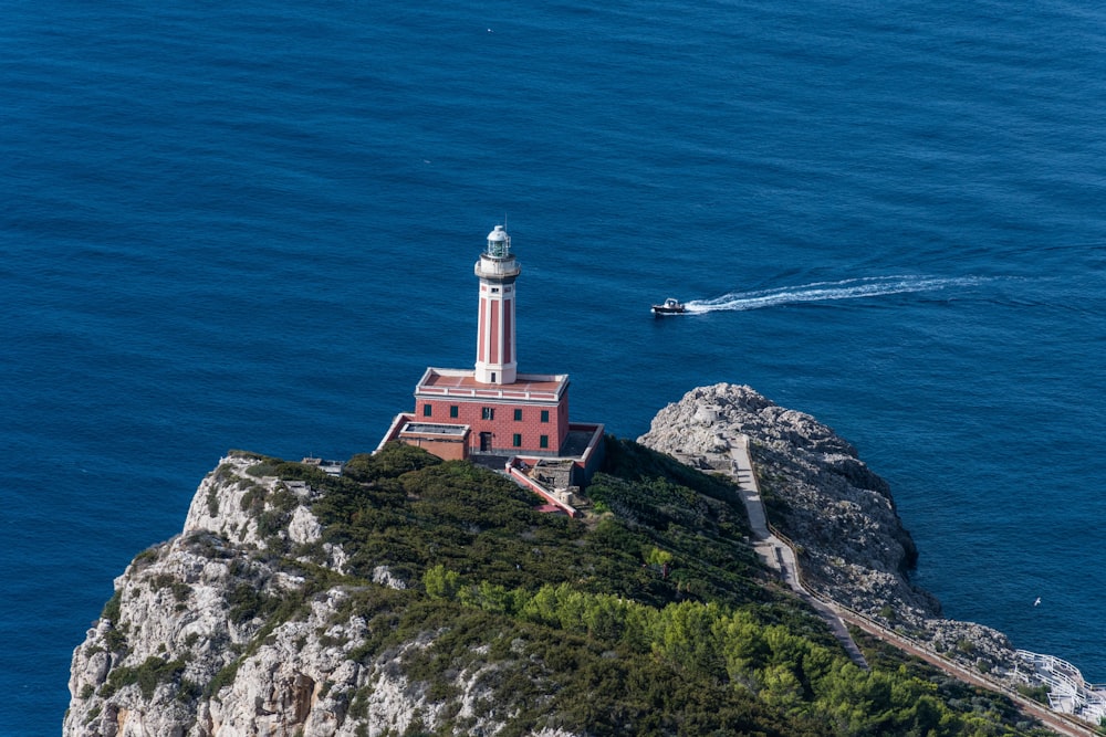 a lighthouse on a small island in the middle of the ocean