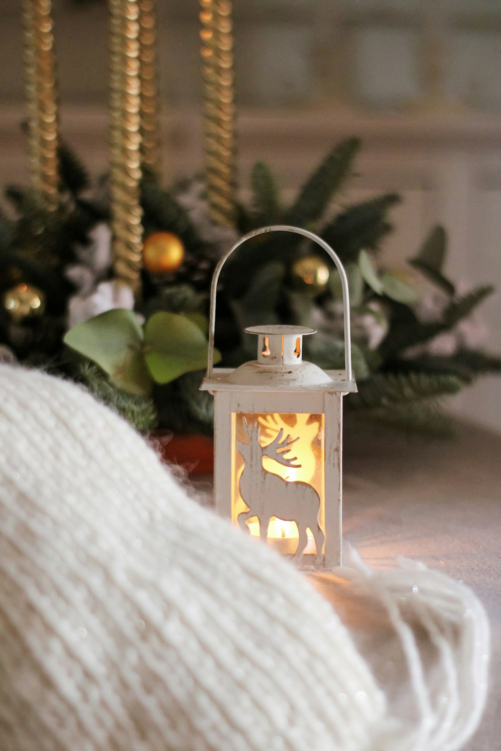 a white lantern sitting on top of a table