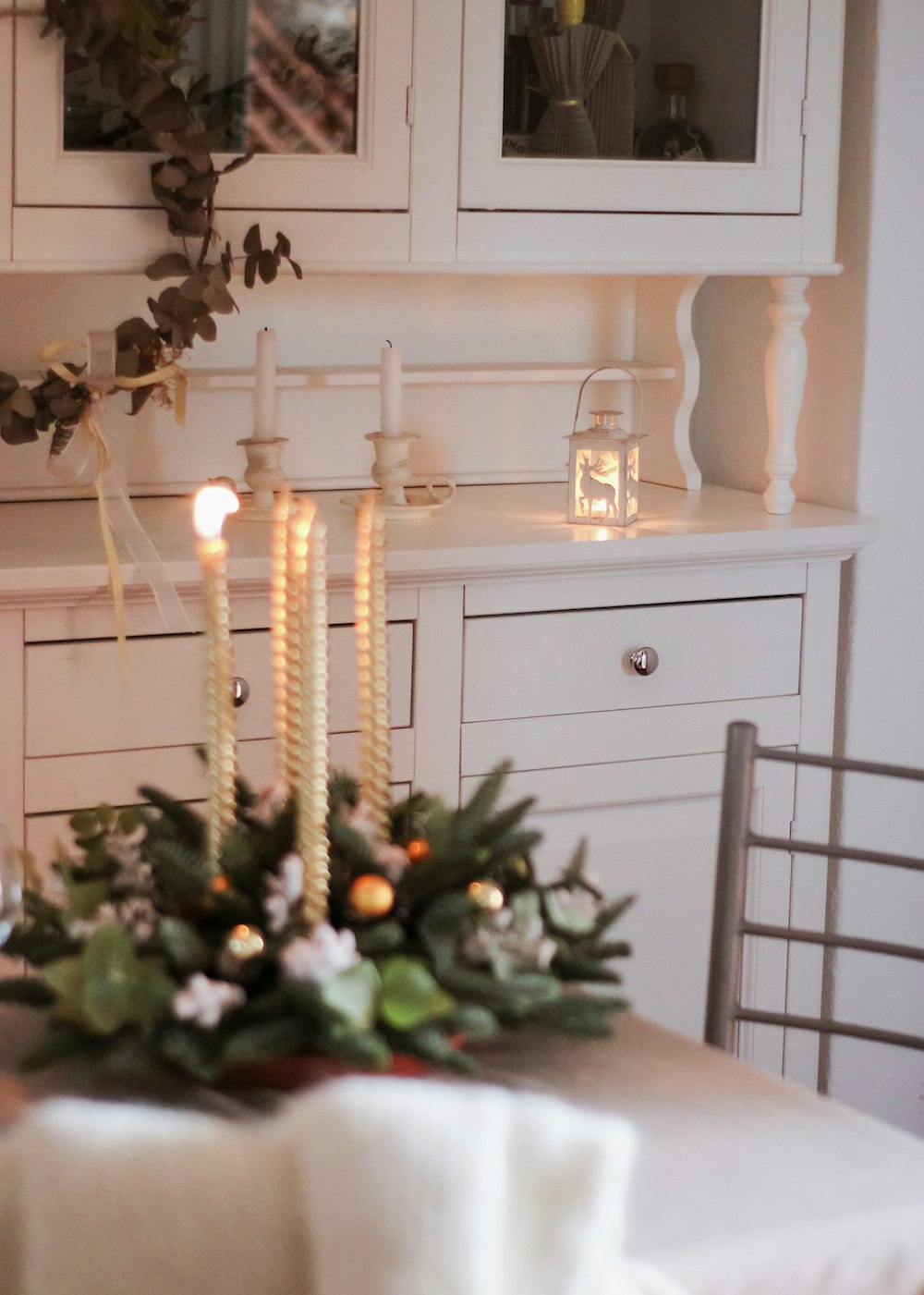 a room filled with furniture and vase of flowers on a table