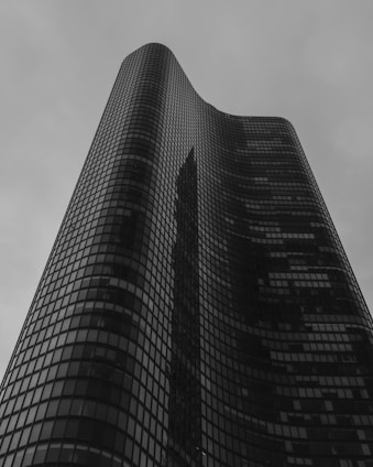 A sleek high-rise luxury apartment with floor-to-ceiling windows overlooking the city skyline.