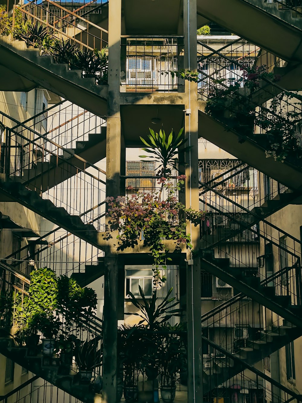 a very tall building with a bunch of plants on it