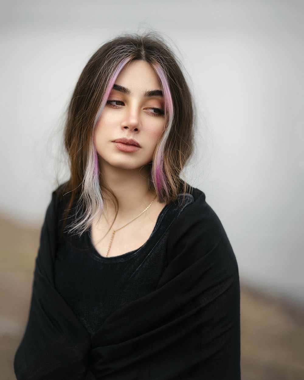 a woman with pink hair and a black shirt