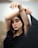 a woman with her arm around her head