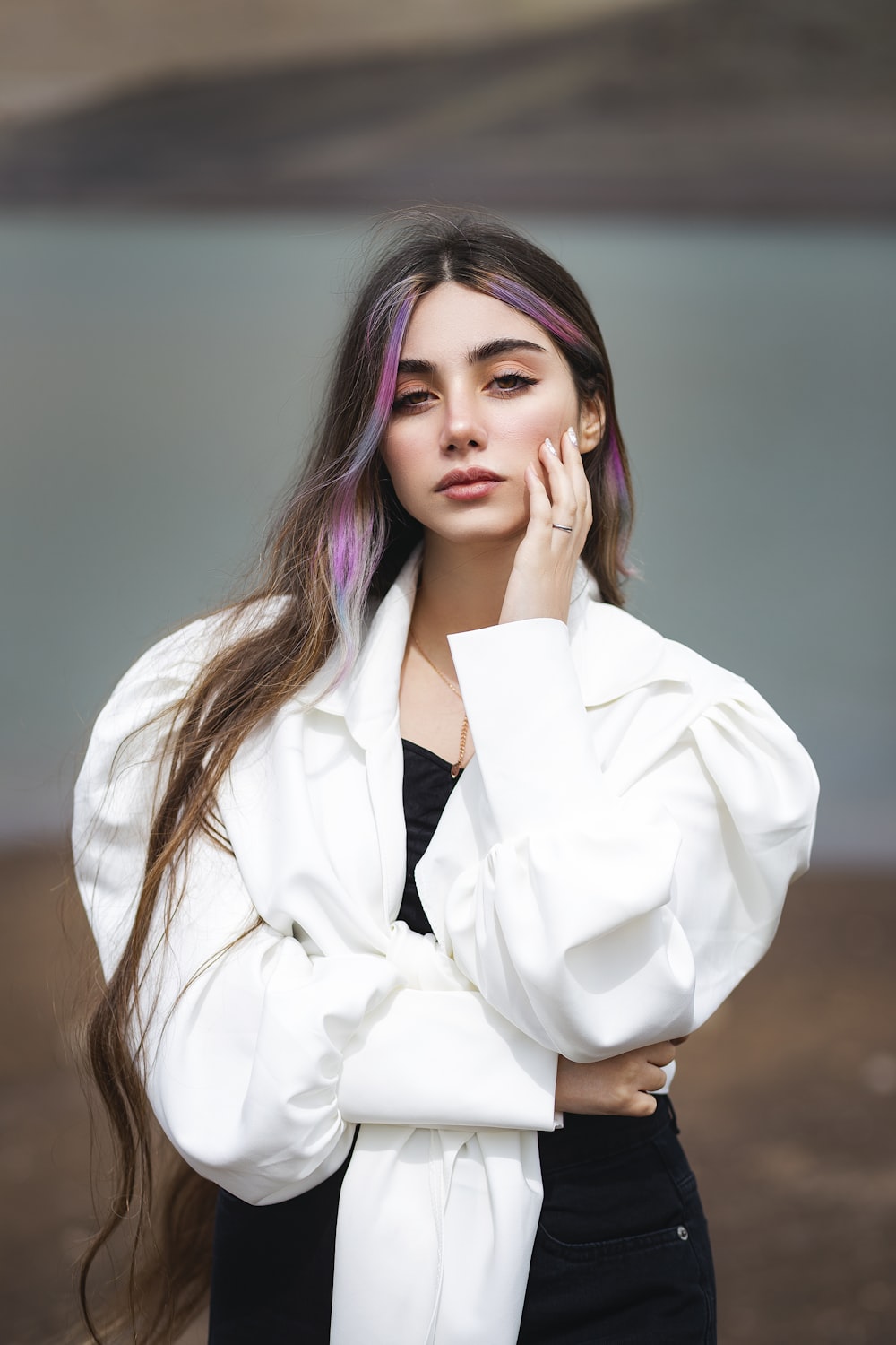 a woman with purple hair is posing for a picture