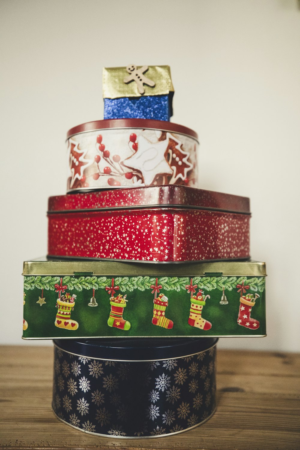 a stack of tins with christmas decorations on them