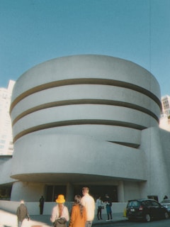 A vibrant panoramic view of the Guggenheim Museum in Bilbao under a clear blue sky.