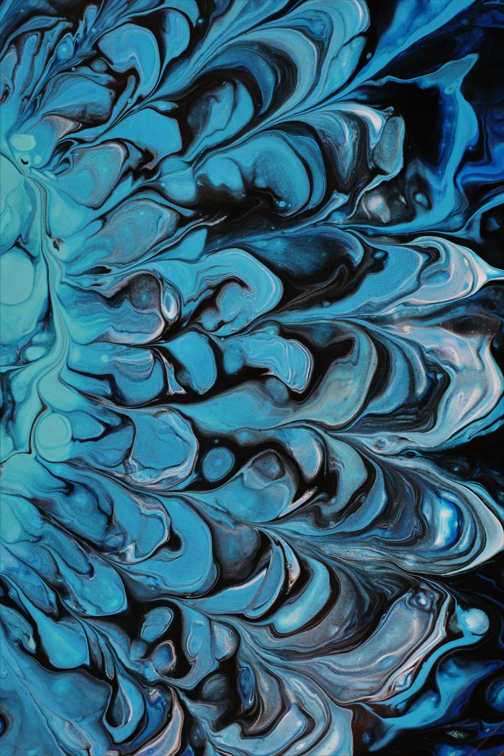 an abstract painting of blue and black colors