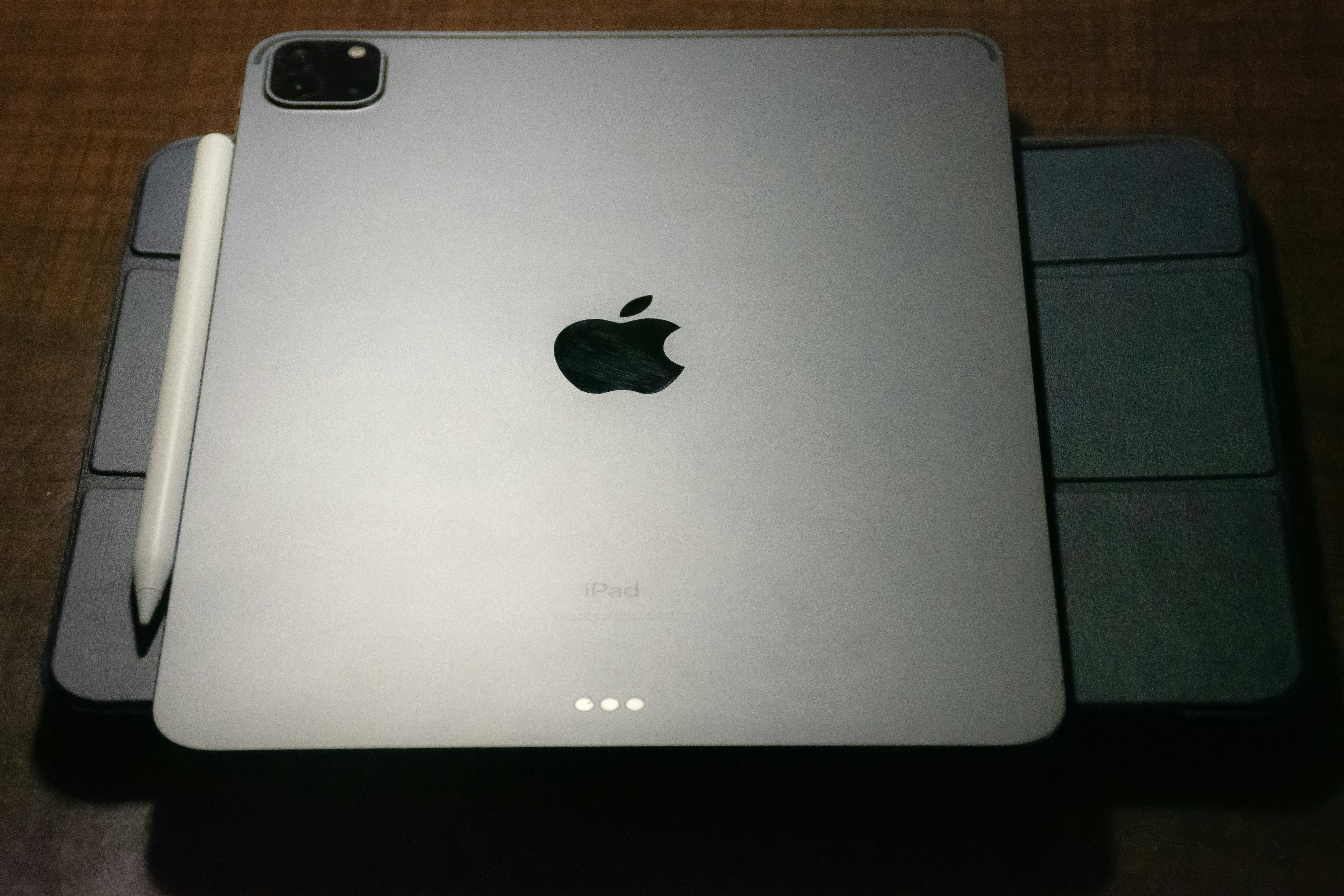 iPad Pro with Apple Pencil on wooden surface