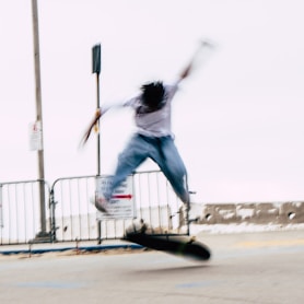 a man riding a skateboard down the side of a road