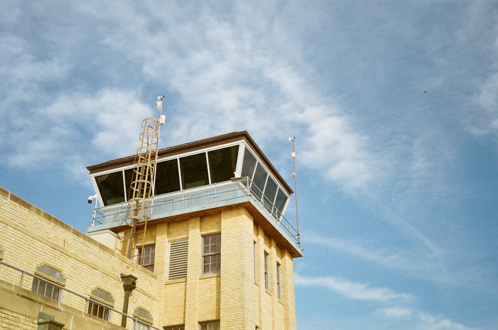 a tall yellow building with a sky background