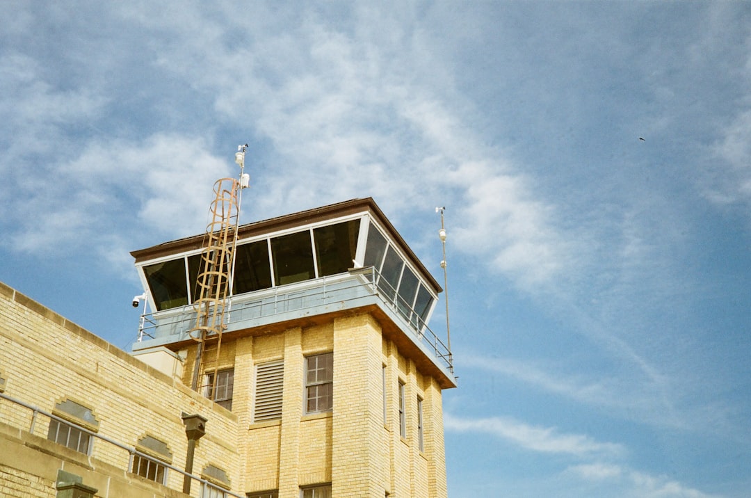 a tall yellow building with a sky background, olympus 35 rc on underexposed kodak gold 200