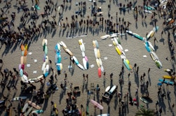 a group of people standing on top of a sandy beach